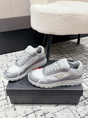 PRADA 25S MEN SNEAKERS IN GRAY AND WHITE CANVAS
