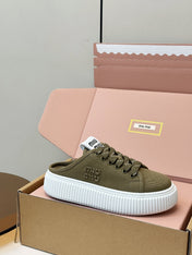 MIUMIU 26S SNEAKER MULES IN OLIVE GREEN CANVAS