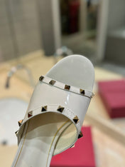 ROCKSTUD MULE SANDALS WITH TRANSPARENT HEEL IN WHITE CALFSKIN